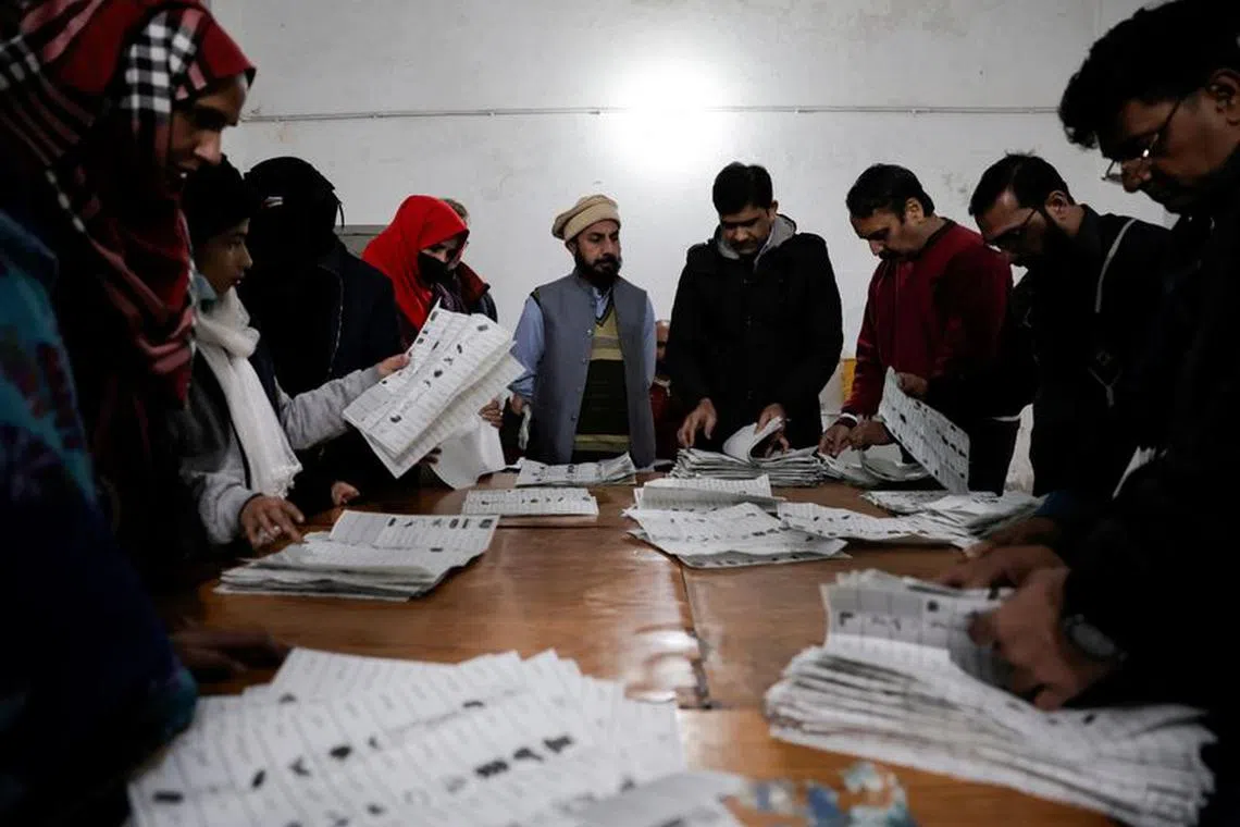 FILE PHOTO: Polling staff count ballots at a polling station after polls closed, during the general election, in Lahore, Pakistan, February 8, 2024. REUTERS/Navesh Chitrakar/File Photo