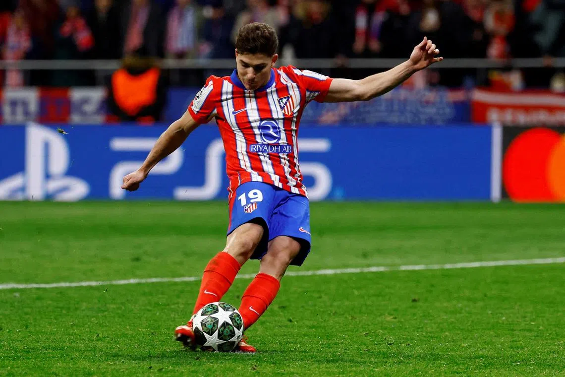 Atletico Madrid's Julian Alvarez scores a penalty during the penalty shootout wich is later disallowed after a VAR review for a double touch.