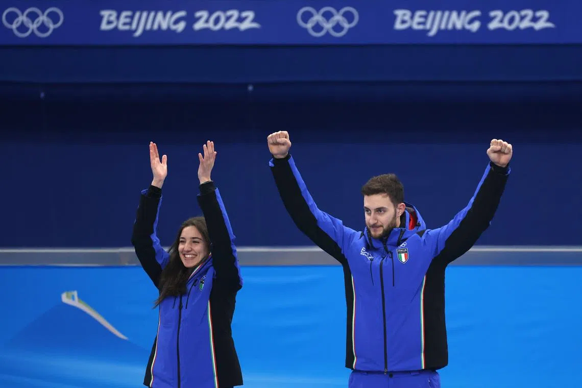 2022 Beijing Olympics - Curling - Victory Ceremony - Curling Mixed Doubles MD Gold Medal - National Aquatics Center, Beijing, China - February 8, 2022. Gold medallists Stefania Constantini of Italy and Amos Mosaner of Italy celebrate. REUTERS/Evelyn Hockstein