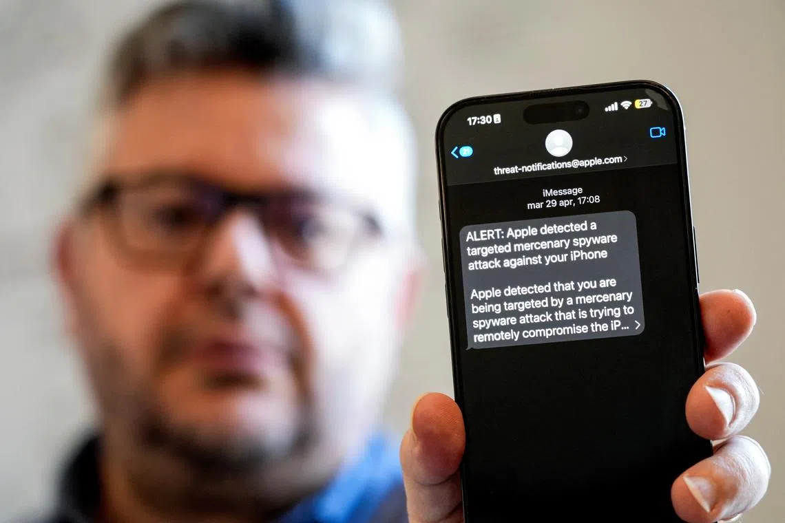 Italian investigative journalist Ciro Pellegrino shows his phone screen displaying a threat notification from Apple warning of a mercenary spyware attack, in Naples, Italy, June 11, 2025. REUTERS/Matteo Ciambelli/File Photo
