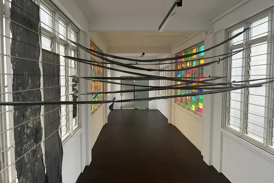 Artist Crystal Lee's On Letting Go (2024) is an installation featuring naturally dyed textiles that deal with the themes of holding on and letting go at 195 Pearl's Hill Terrace.