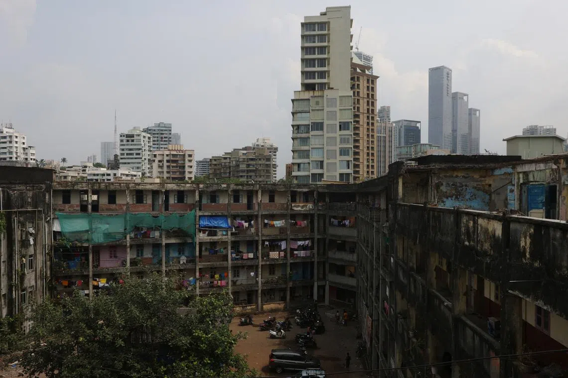 Buildings are seen behind the Worli dairy quarters building on Oct 5, 2022. "It's dangerous, especially with parents and children," added resident Sumit Shinde. "But it's not possible for me, or any middle class family, to purchase a new home in Mumbai. It's very expensive."   