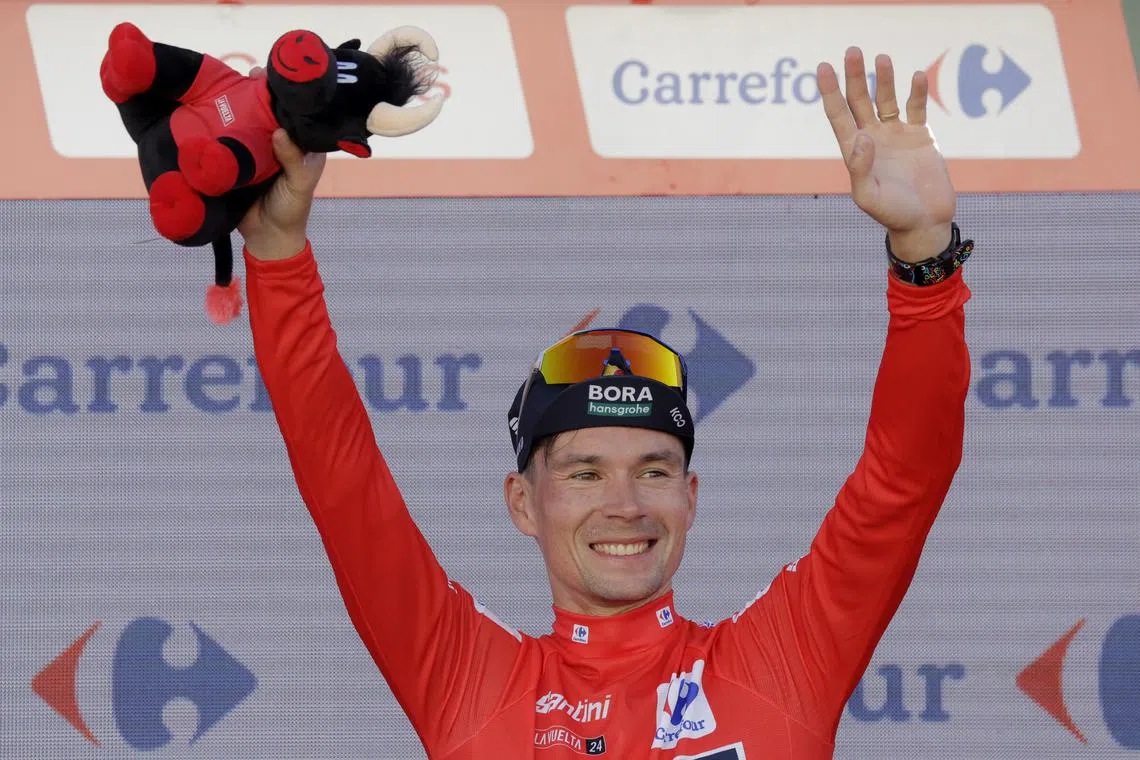 FILE PHOTO: Cycling - Vuelta a Espana - Stage 5 - Fuente del Maestre to Seville - Spain - August 21, 2024 Red Bull - Bora - Hansgrohe's Primoz Roglic celebrates while wearing the red jersey on the podium after stage 5 REUTERS/Jon Nazca/File Photo