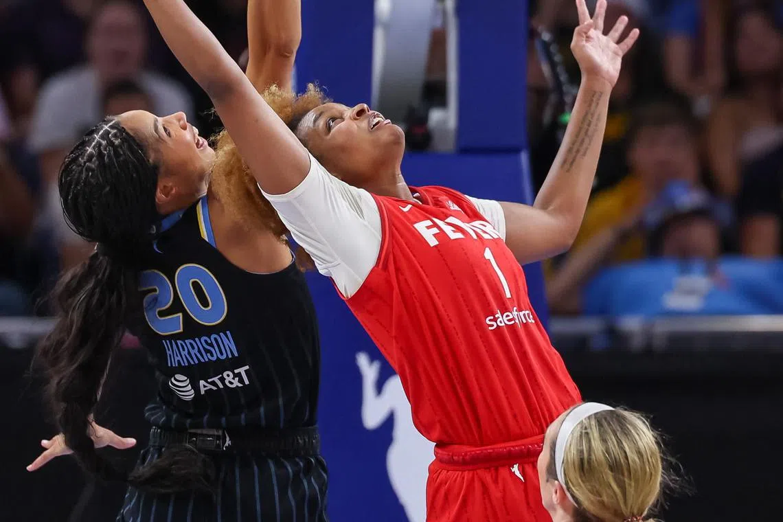Isabelle Harrison #20 of the Chicago Sky and NaLyssa Smith #1 of the Indiana Fever reach for the ball during the game at Wintrust Arena on Aug 30 in Chicago.