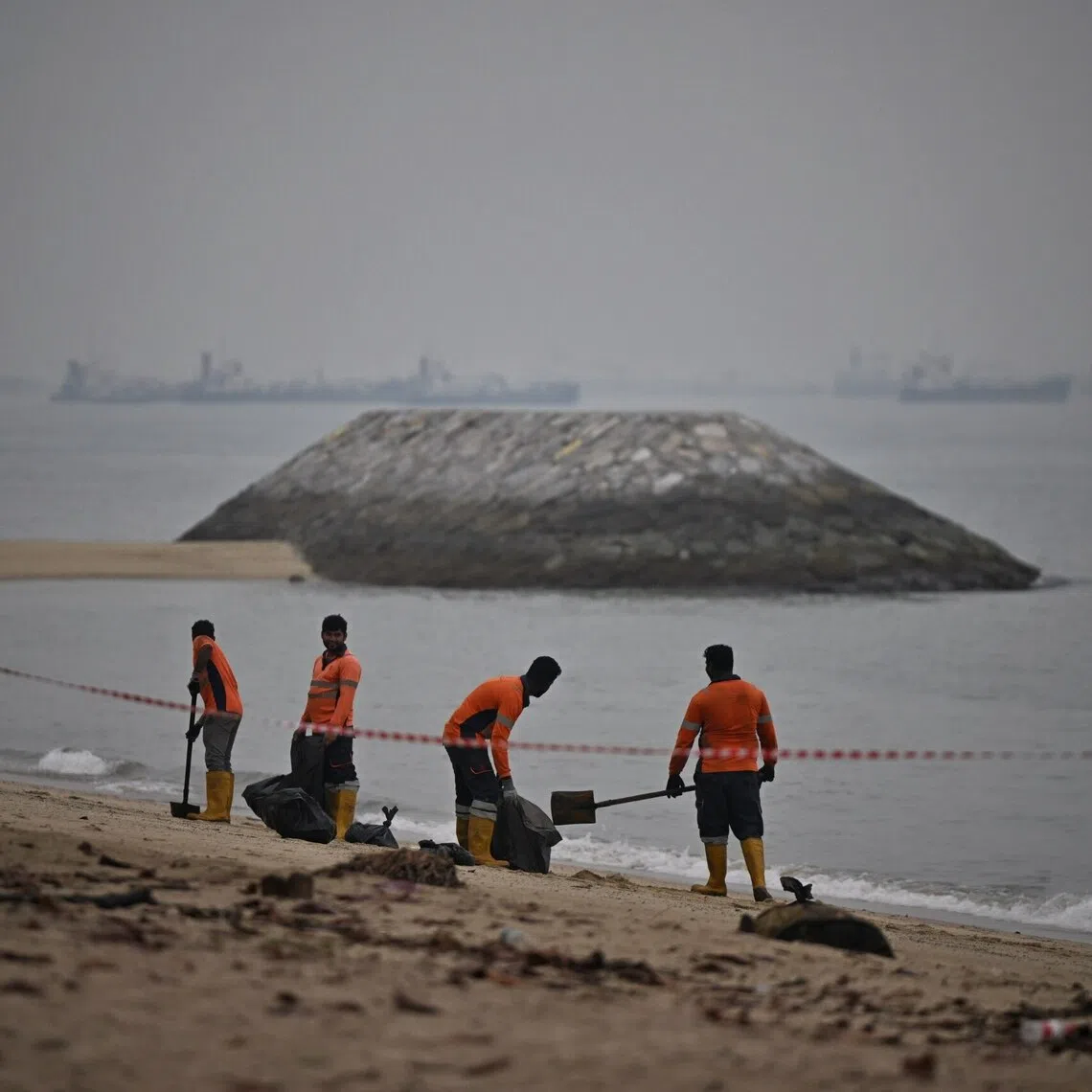 Clean-up operations of the oil patches at East Coast Park area D, on Oct 24.