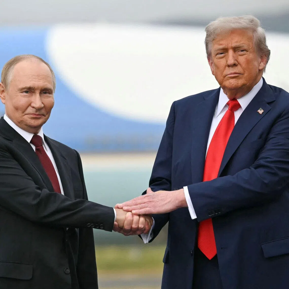 US President Donald Trump greets Russian President Vladimir Putin on the tarmac after they arrived at Joint Base Elmendorf-Richardson in Anchorage, Alaska, on Aug 15, 2025.