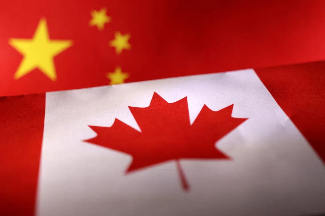 FILE PHOTO: Printed Chinese and Canada flags are seen in this illustration, July 21, 2022. REUTERS/Dado Ruvic/Illustration/File Photo