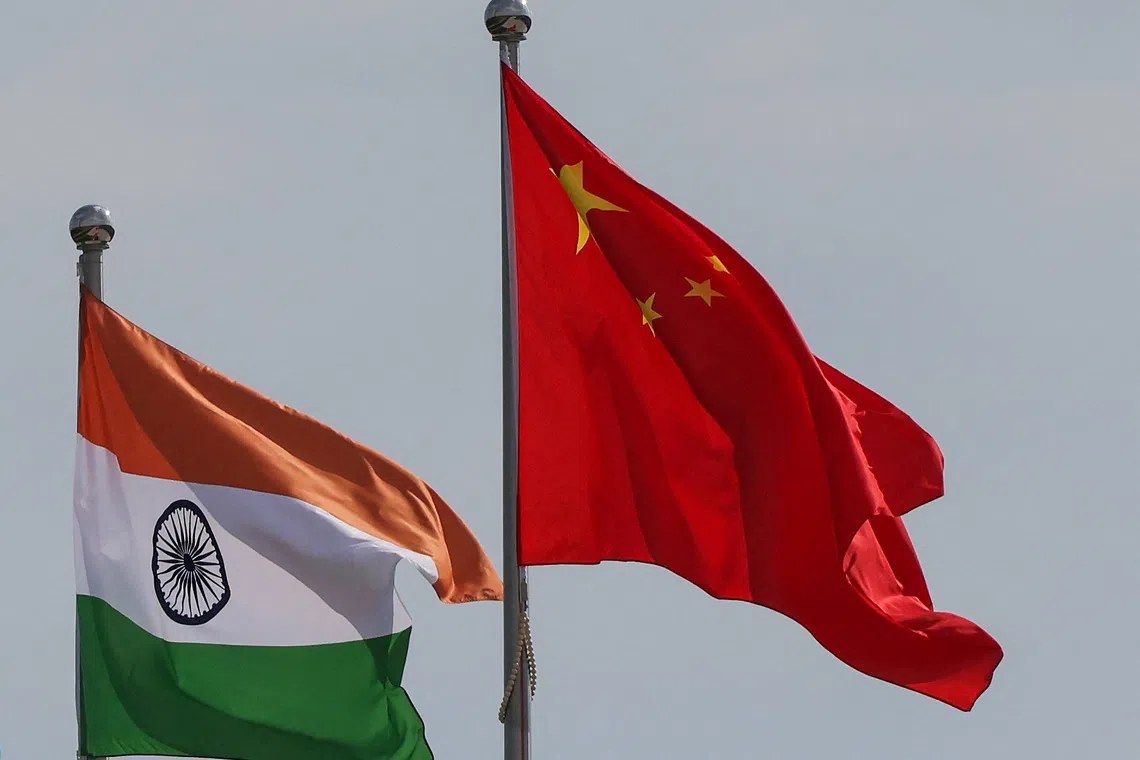 National flags of China and India fly next to the Meijiang Convention and Exhibition Center, a venue for 2025 Shanghai Cooperation Organisation (SCO) summit in Tianjin, China August 30, 2025. REUTERS/Maxim Shemetov