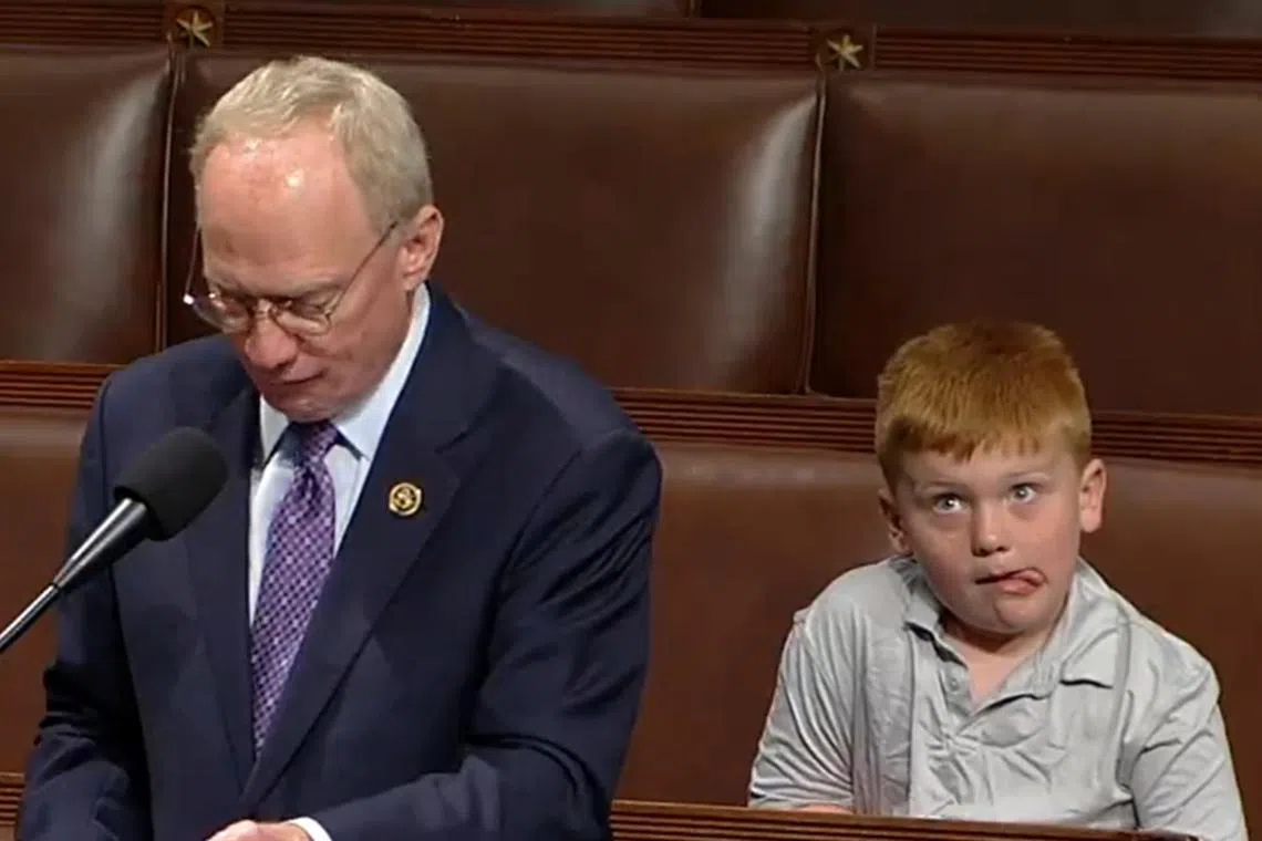 As Representative John W. Rose (left) spoke on the House floor, his son Guy, 6, put on a performance of his own.