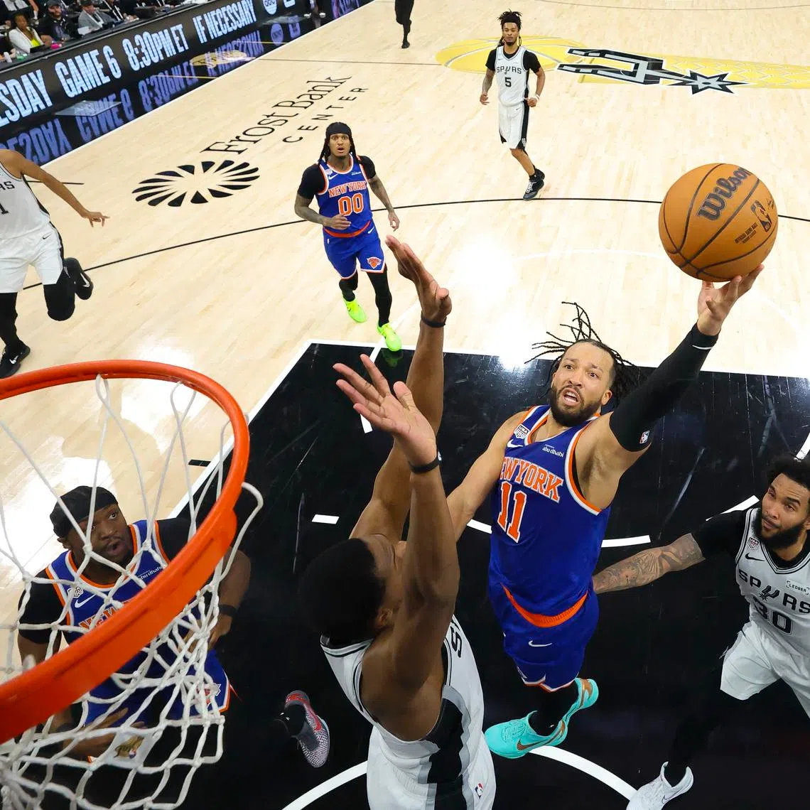 Jun 13, 2026; San Antonio, Texas, USA; New York Knicks guard Jalen Brunson (11) drives to the basket past San Antonio Spurs forward Julian Champagnie (30) during game five of the 2026 NBA Finals at Frost Bank Center. Mandatory Credit: Geoff Burke-Pool Photo via Imagn Images