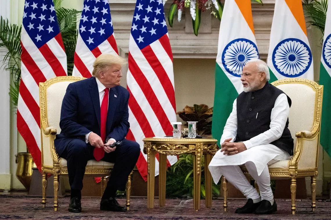 FILE PHOTO: Indian Prime Minister Narendra Modi speaks to U.S. President Donald Trump during a meeting at Hyderabad House in New Delhi, India, February 25, 2020. REUTERS/Al Drago/File Photo