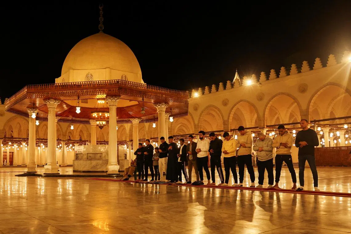 Muslim worshippers take part in evening prayers called "Tarawih" during the eve of the first night of the Muslim holy fasting month of Ramadan, at Amr Ibn El-Aas mosque in old Cairo, Egypt.

