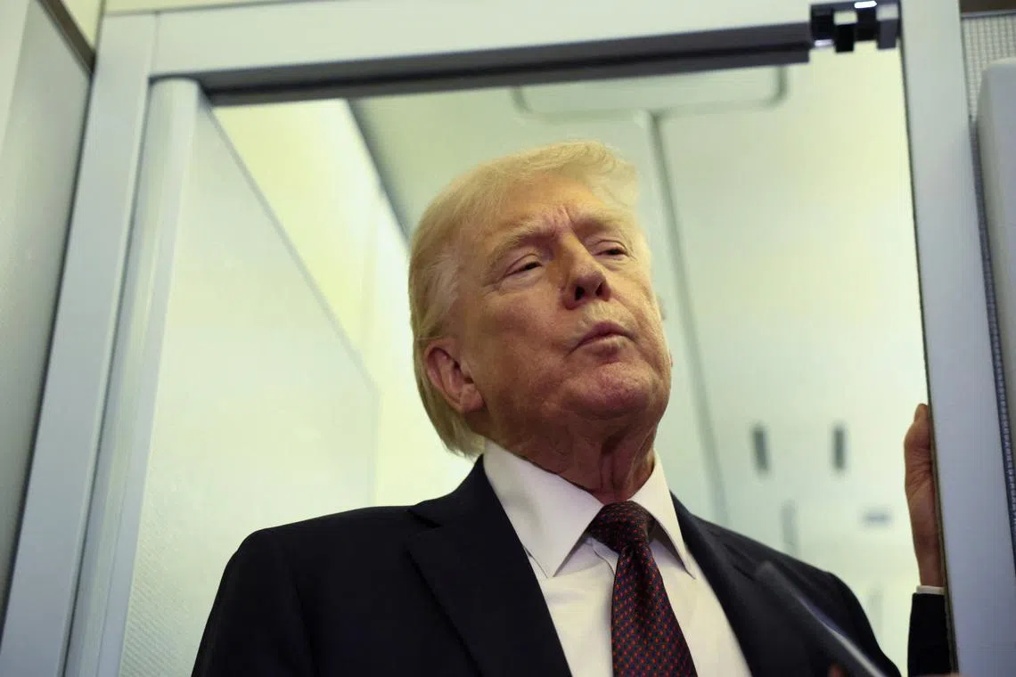 U.S. President Donald Trump speaks to reporters aboard Air Force One on a flight back to Washington March 15, 2026. REUTERS/Kevin Lamarque