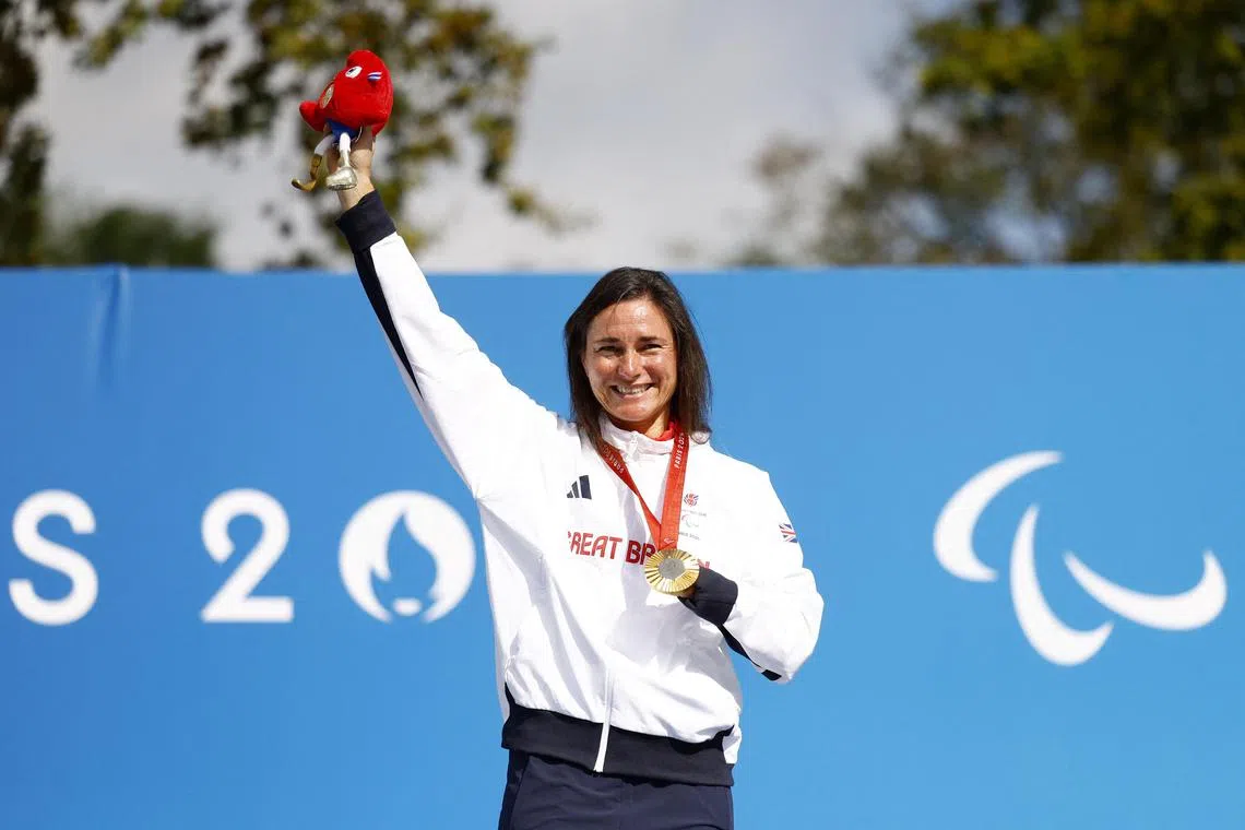Gold medallist Sarah Storey of Britain celebrates with her medal on the podium after winning the C5 time trial at the Paris Paralympics.