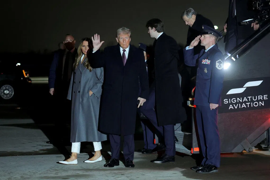 U.S. President-elect Donald Trump, his wife Melania and son Barron arrive at Washington Dulles International Airport in Dulles, Virginia, U.S., January 18, 2025. REUTERS/Carlos Barria