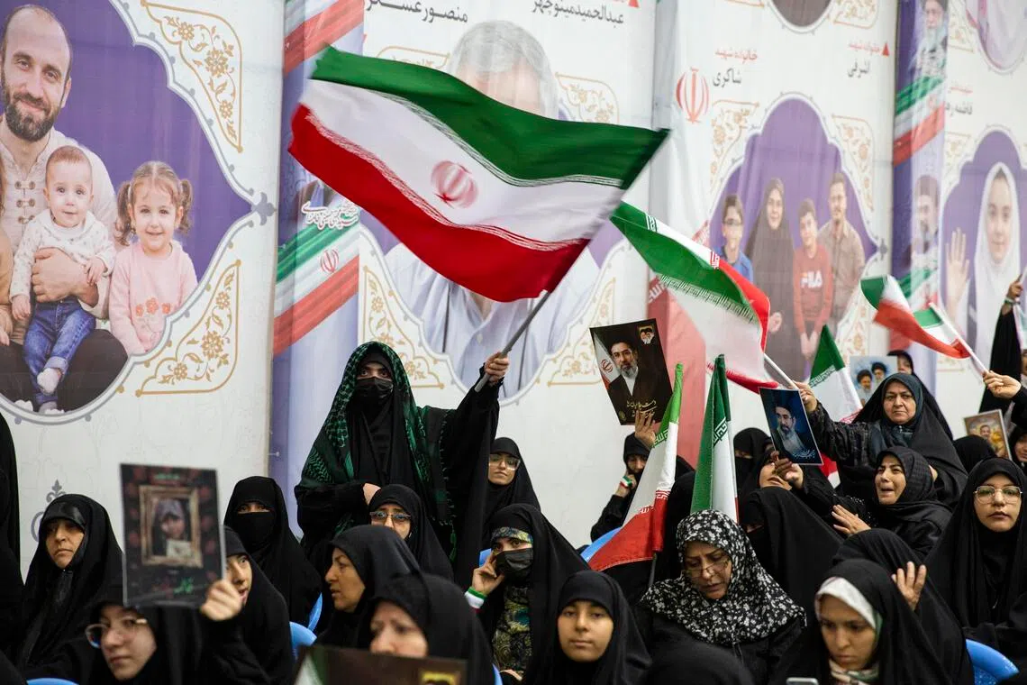 Attendees at a memorial ceremony for the victims of the war with the US and Israel, in Tehran on May 24.