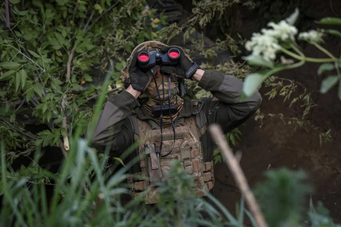 A Ukrainian serviceman from an air defence unit monitoring the sky at a frontline, amid Russia's attack on Ukraine, near the town of Bakhmut, Ukraine, on May 23, 2024. 