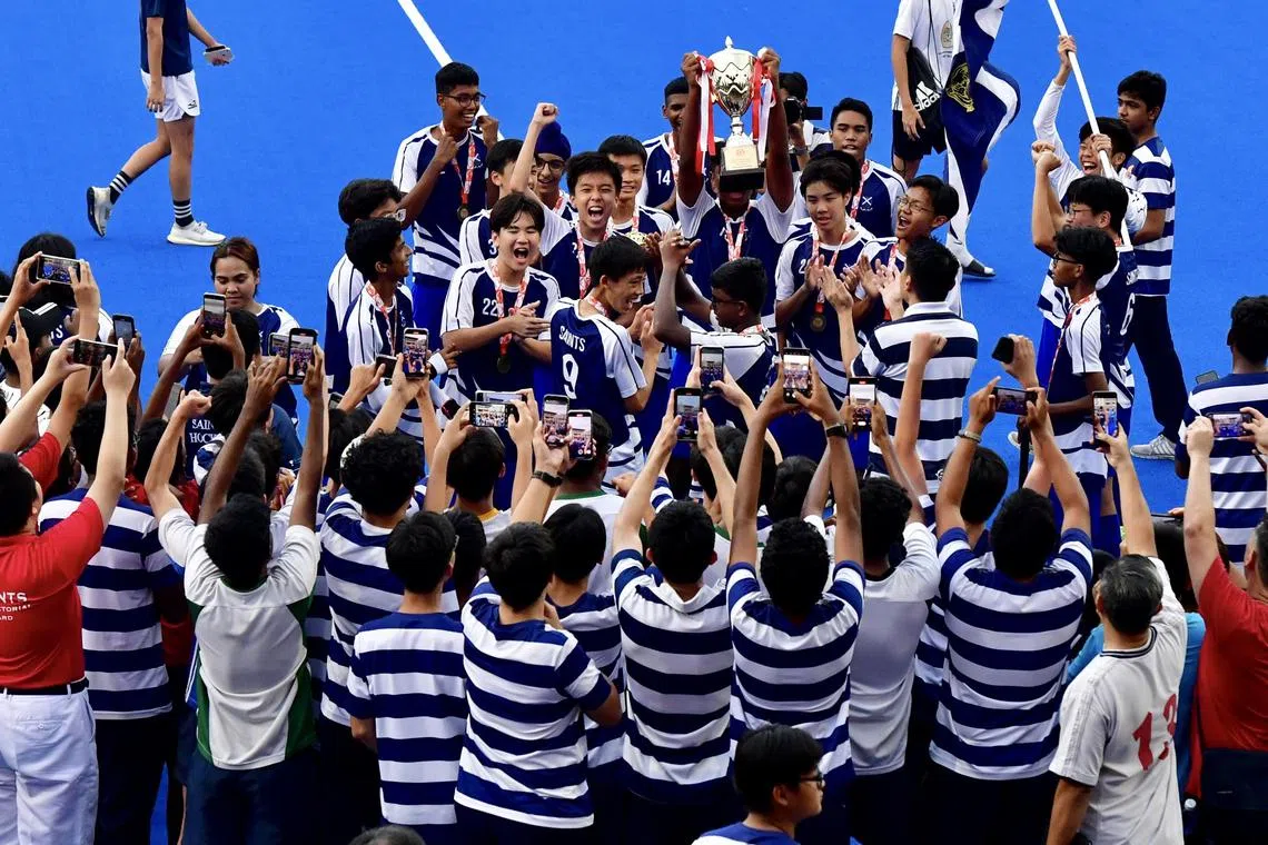 A jubilant St. Andrew’s team celebrating with supporters and schoolmates after clinching the ‘B’ Division title