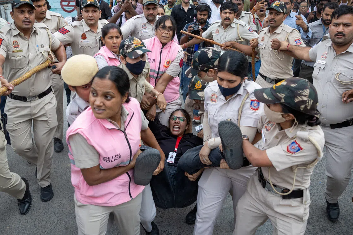 Police detain a journalist during a protest by the Cockroach Janta Party seeking the resignation of India’s Chief Election Commissioner Gyanesh Kumar in New Delhi on Oct 11.
