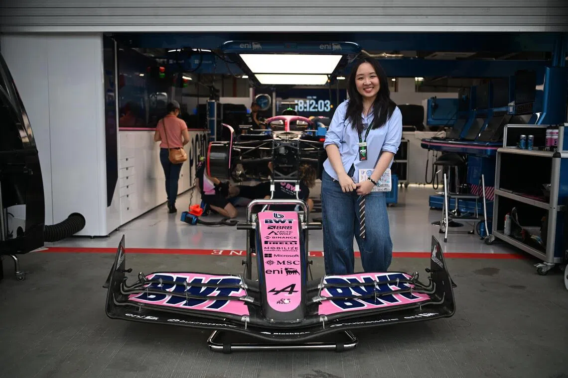 ST20251002_202591100704 Azmi Athni saf103//

The Straits Times writer Sarah Koh poses in front of the BWT Alpine F1 Team garage at the Singapore circuit on Thursday, Oct 2, 2025. 

ST PHOTO: AZMI ATHNI

[NOTE: F1 photos are for editorial use only and NOT for sale.]
