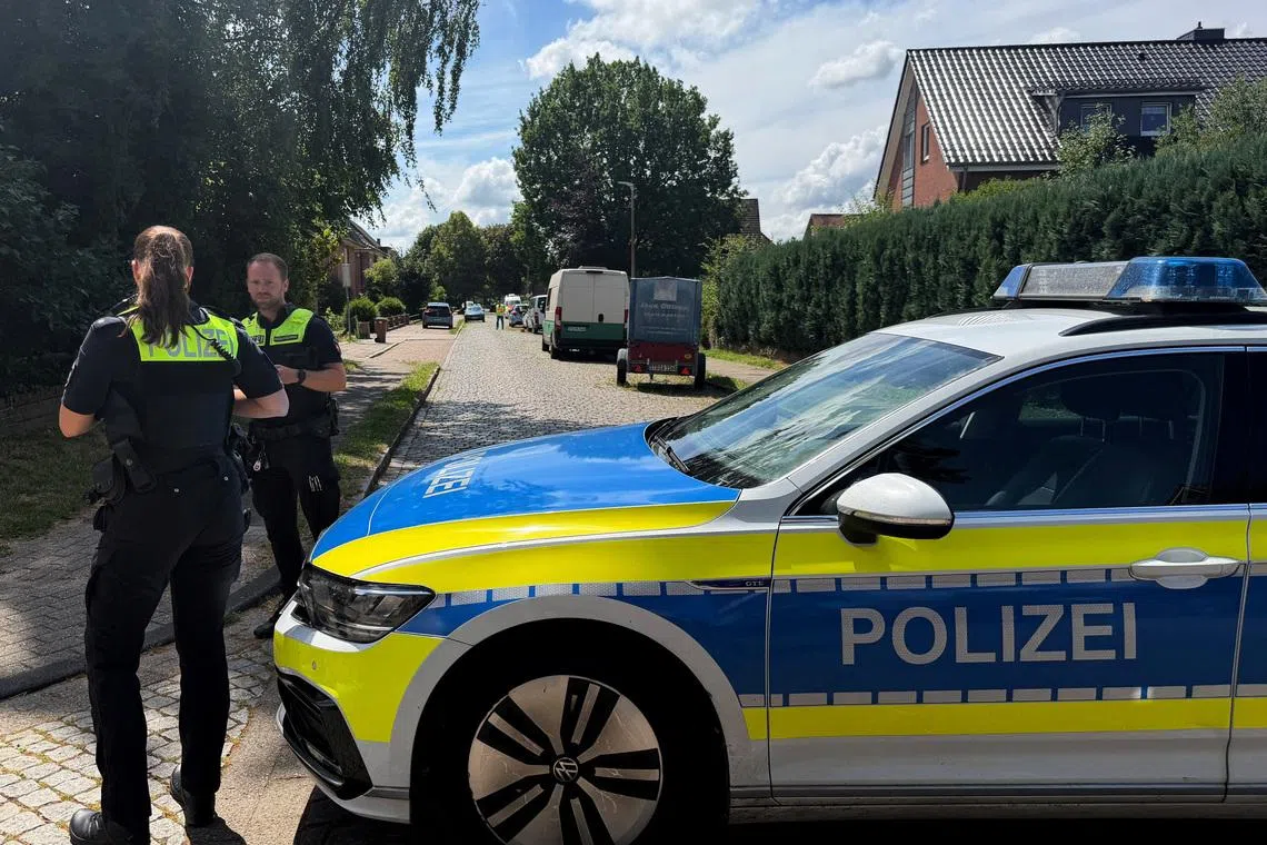 Police secure a youth welfare facility in the northern German town of Stade where at least five people were gunned down.