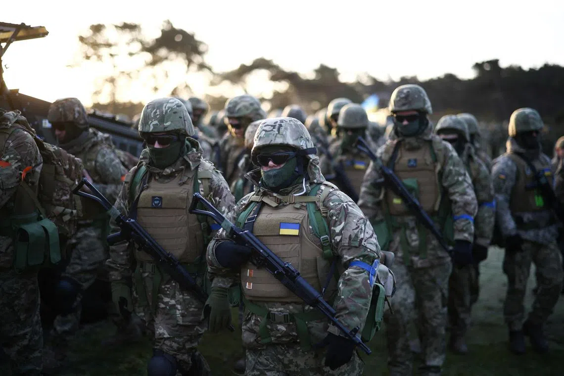 Ukrainian military recruits at a ceremony marking the first anniversary of the Russian invasion, at a military base in Britain, on Feb 24.