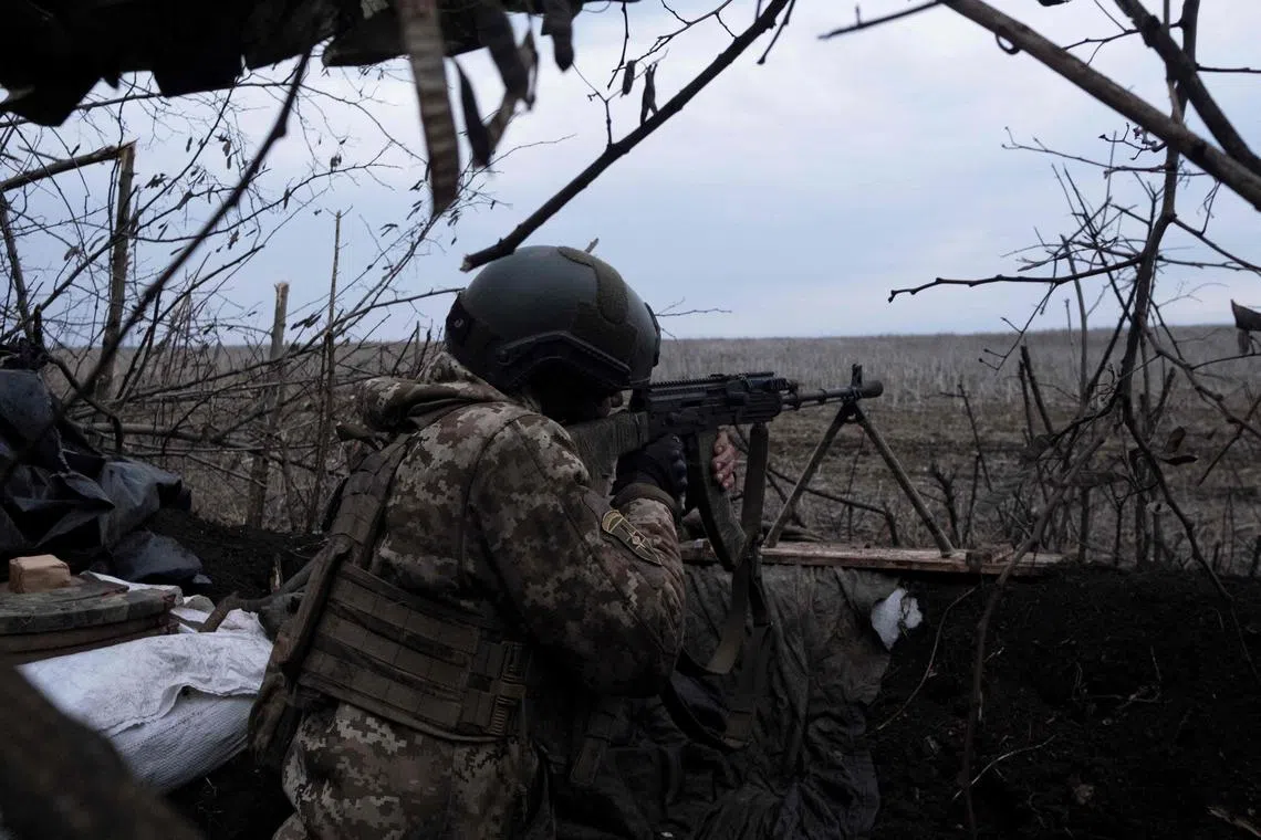 A soldier of the Ukrainian Volunteer Army fires at Russian front line positions near Bakhmut, Donetsk region, on March 11, 2023, amid the Russian invasion of Ukraine. (Photo by Sergey SHESTAK / AFP)
