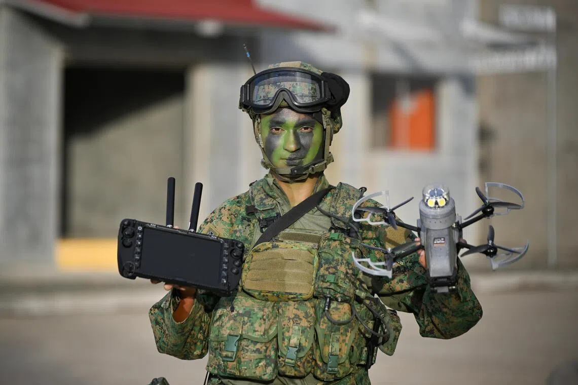 Steel Net section commander Scott Michael Thomas, 20, holding the Artos attack drone in the Shoalwater Bay Training Area in Queensland, Australia, on Oct 22.