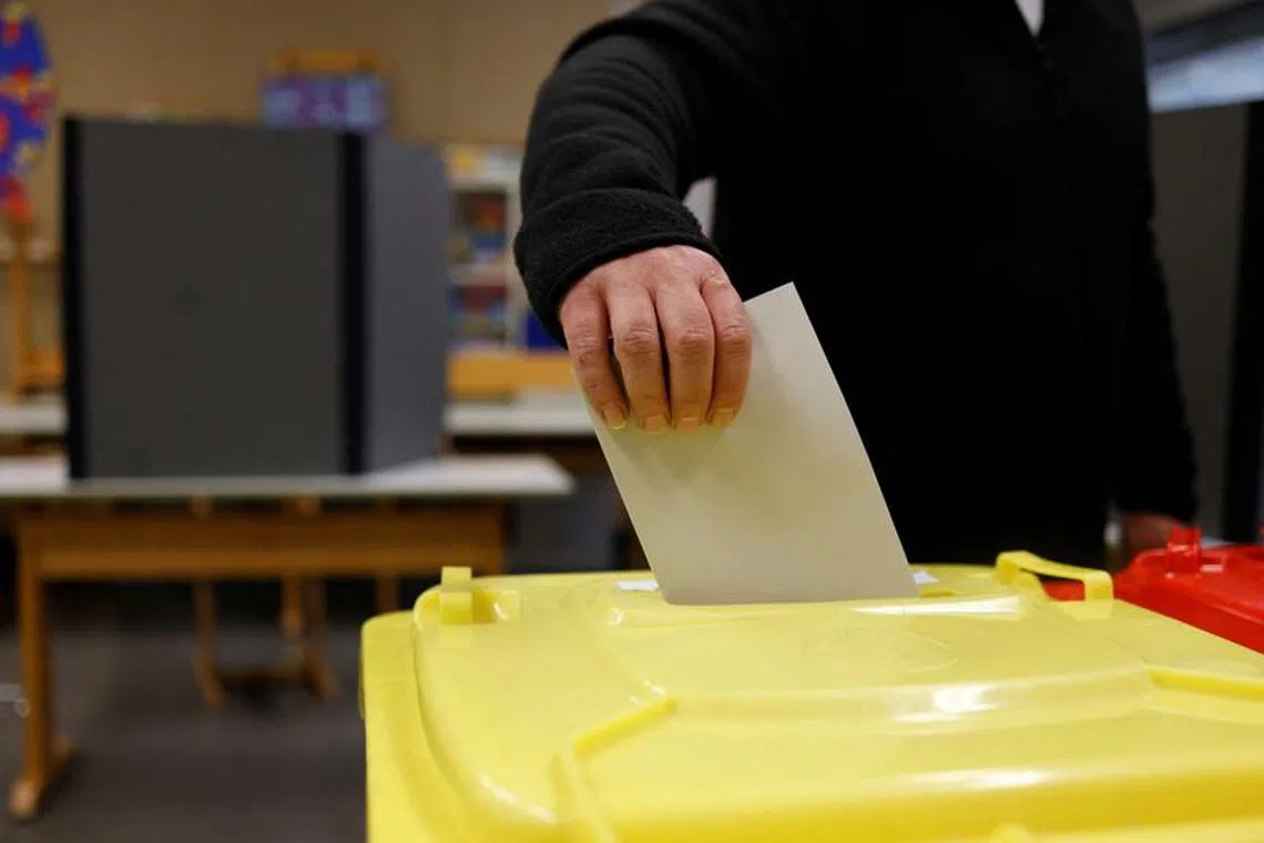 A voter casts their ballot during the Bavarian state election, in Nuremberg, Bavaria, Germany, October 8, 2023. REUTERS/Michaela Rehle