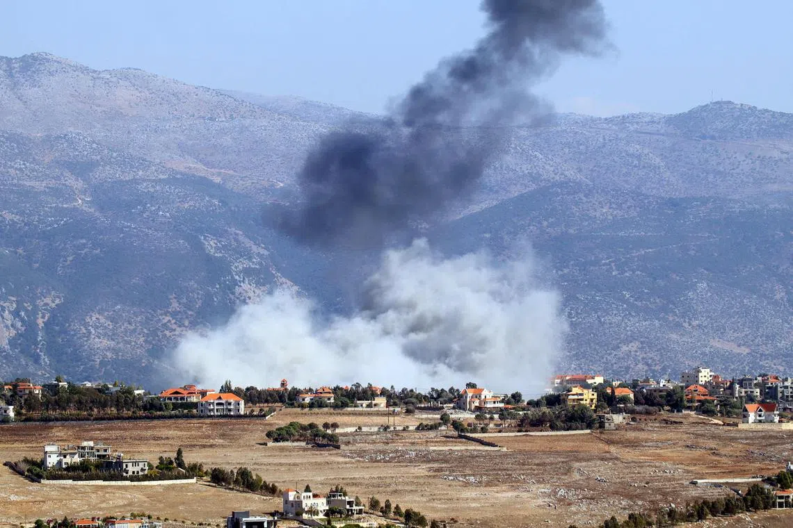 Smoke rising from the site of an Israeli air strike that targeted the southern Lebanese village of Khiam on Oct 8.