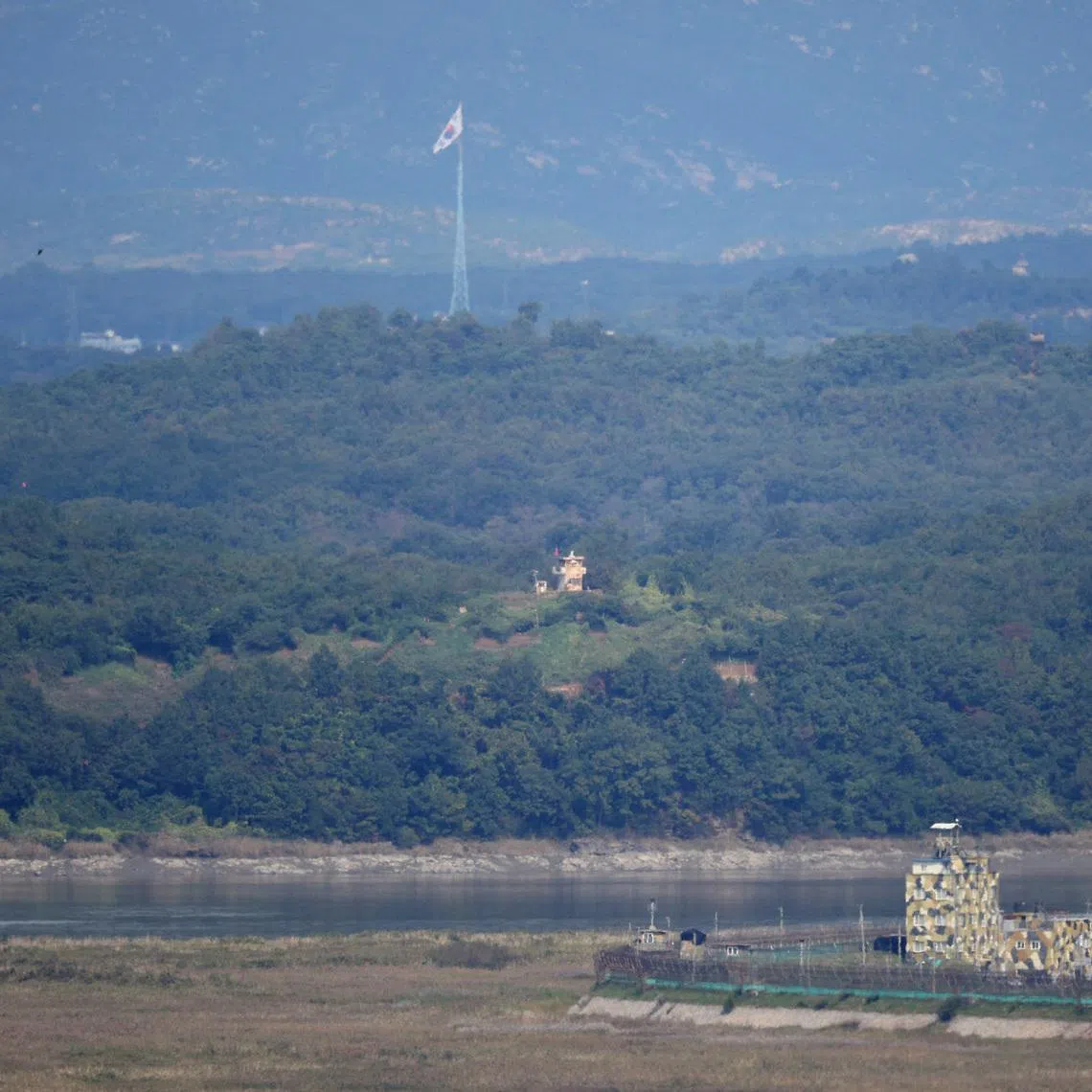 South and North Korean guard posts face each other as a South Korean national flag flutters in this picture taken from the Unification Observation Platform, near the demilitarized zone which separates the two Koreas in Paju, South Korea, October 6, 2022. REUTERS/Kim Hong-Ji