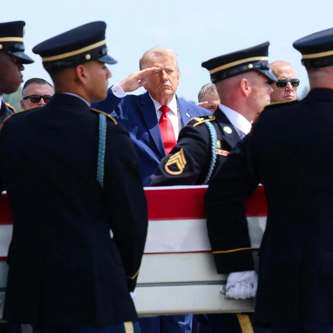 DOVER, DELAWARE - JULY 22: U.S. President Donald Trump (C) salutes as members of a U.S. Army carry team move the flag-draped transfer case holding the remains of Army Pvt. Isabella Gonzales, of Carrollton, Texas, during a dignified transfer at Dover Air Force Base July 22, 2026 in Dover, Delaware. Pvt. Gonzales, who was assigned to 1st Battalion, 57th Air Defense Artillery Regiment, 52nd Air Defense Artillery Brigade, 10th Army Air Missile Defense Command in Ansbach, Germany, was killed in action during an enemy attack on July 17, 2026, at Muwaffaq Salti Air Base in Jordan.   Kevin Dietsch/Getty Images/AFP (Photo by Kevin Dietsch / GETTY IMAGES NORTH AMERICA / Getty Images via AFP)