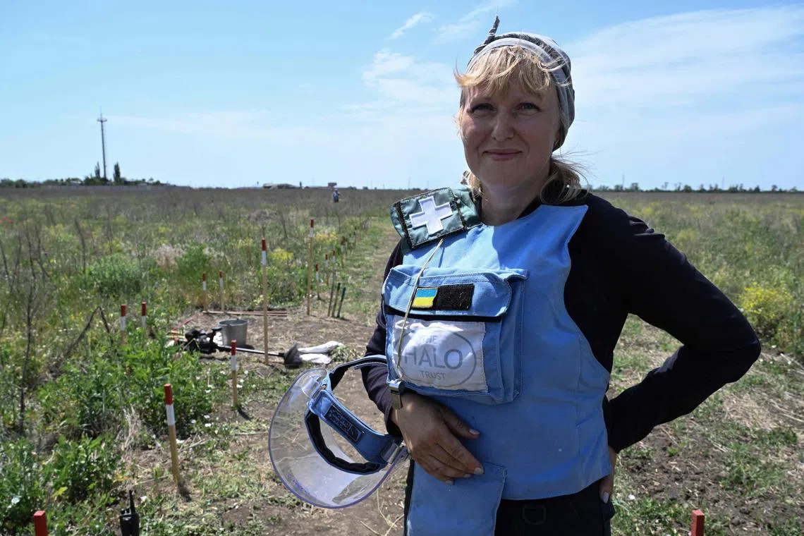 Deminer Tetiana Shpak in a field outside the village of Snigurivka, Mykolaiv region, on June 4.