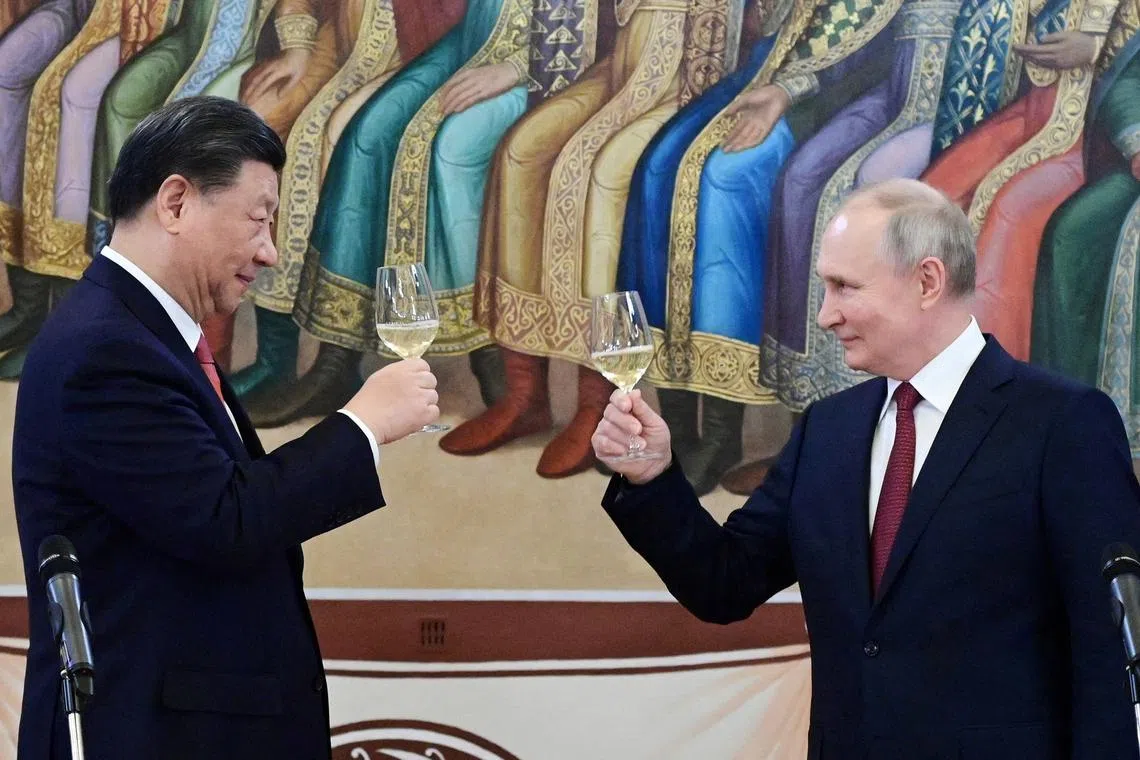 Chinese President Xi Jinping (left) and Russian President Vladimir Putin during a reception in Russia on March 21.