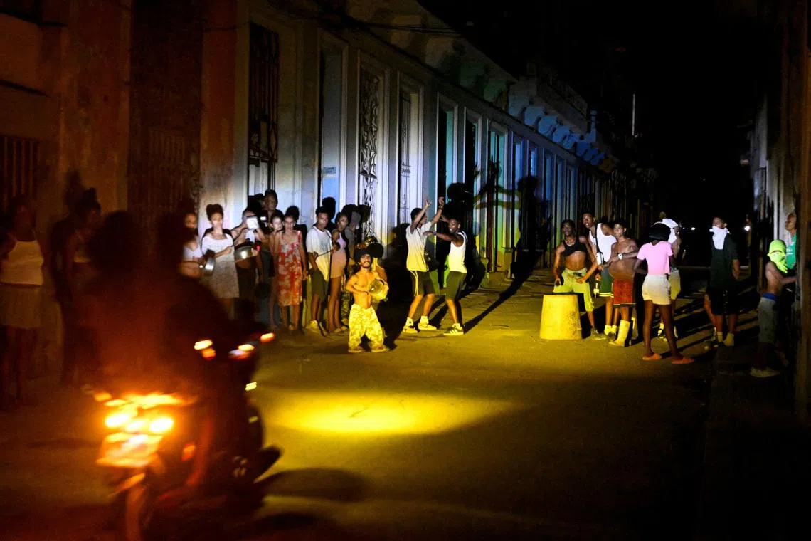 People gather on a street during a blackout as Cuba's national electric grid collapsed, according to the country's grid operator, leaving around 10 million people without power amid a U.S.-imposed oil blockade, in Havana, Cuba March 16, 2026.