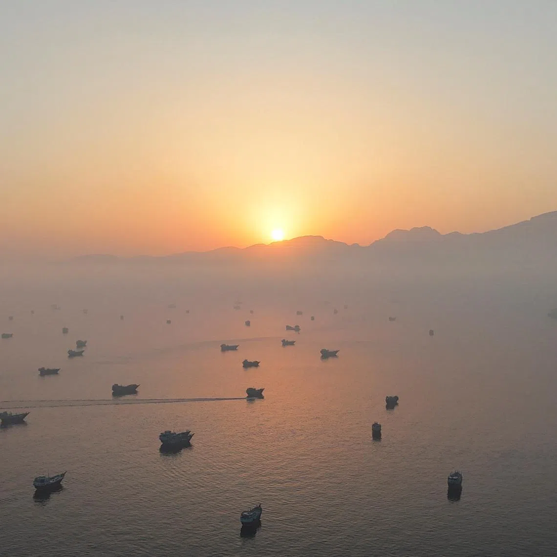 A drone view shows vessels in the Strait of Hormuz, as seen from Musandam, Oman, June 15, 2026. REUTERS/Stringer