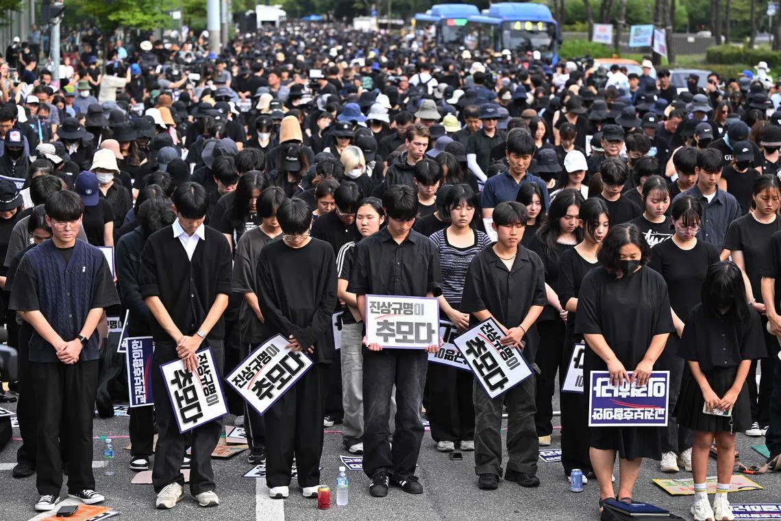 Protesters paying silent tribute to an elementary school teacher who died in an apparent suicide in July, during a rally in Seoul on Sept 4.