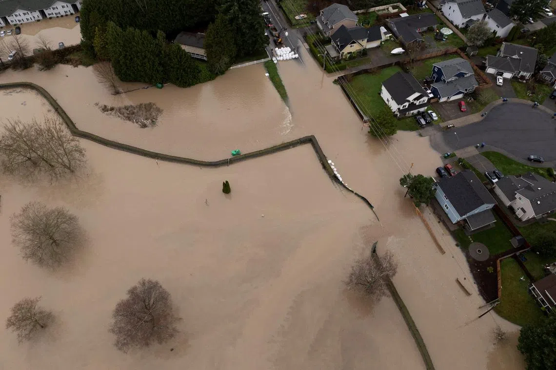 A drone view shows the failure of a temporary flood barrier along the White River, after multiple atmospheric rivers brought rain and flooding to the Pacific Northwest, in Pacific, Washington, U.S., December 16, 2025.  REUTERS/David Ryder