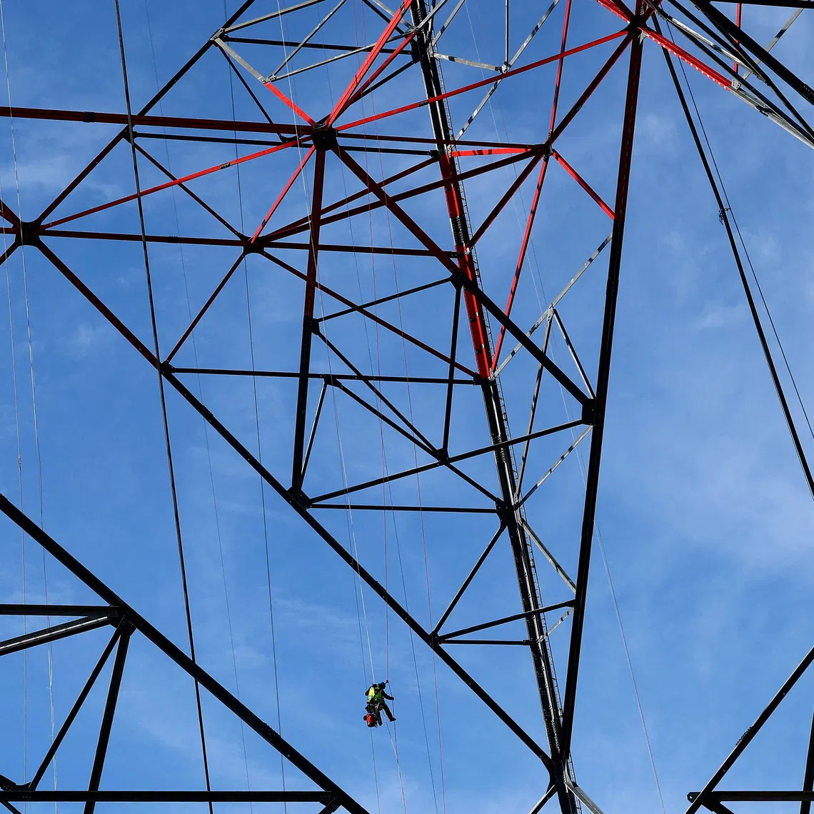 A worker ropes down from a 365-metre wind turbine built by German technology group Gicon in a wind park area near Schipkau, Germany, October 1, 2026. REUTERS/Lisi Niesner TPX IMAGES OF THE DAY