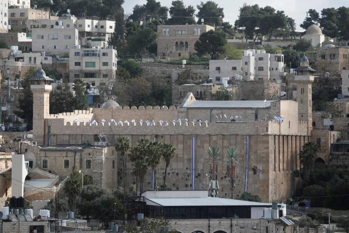 Israeli flags flutter on the Ibrahimi mosque, also known as the Cave of the Patriarchs, in Hebron, in the Israeli-occupied West Bank. 
