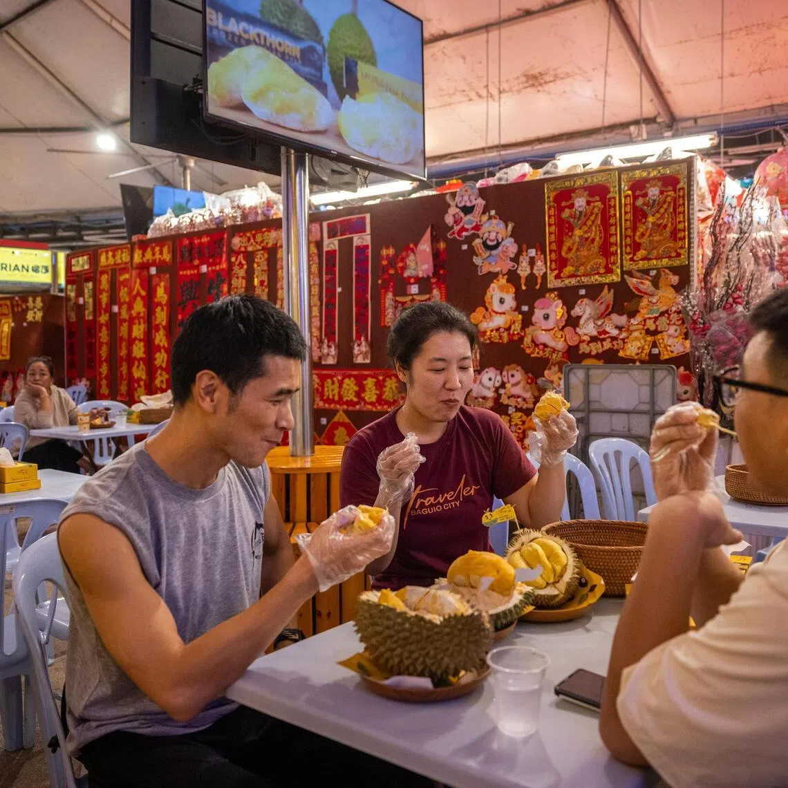 Diners enjoy durian at Durian Wonderland in Kuala Lumpur, Malaysia, Jan 19, 2026. Malaysian durian farmers saw immense profits over the last decade as China snapped up their produce. But tastes have shifted.