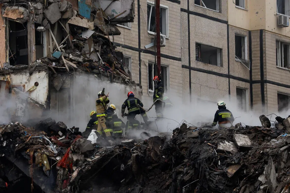 Emergency personnel work at the site of the Dnipro apartment block strike. 
