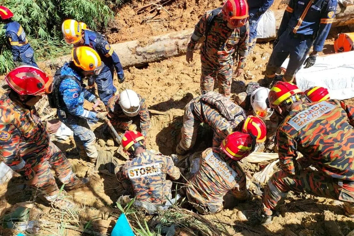 Rescuers work during a rescue and evacuation operation following a landslide at a campsite in Batang Kali, Selangor state, on the outskirts of Kuala Lumpur, Malaysia, Dec 16, 2022, in this picture obtained from social media. 