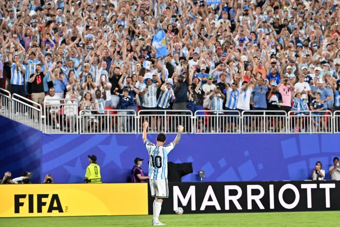 Argentina's Lionel Messi celebrates with supporters after scoring the second goal in their 3-0 win over Algeria in a World Cup Group J match on June 16.
