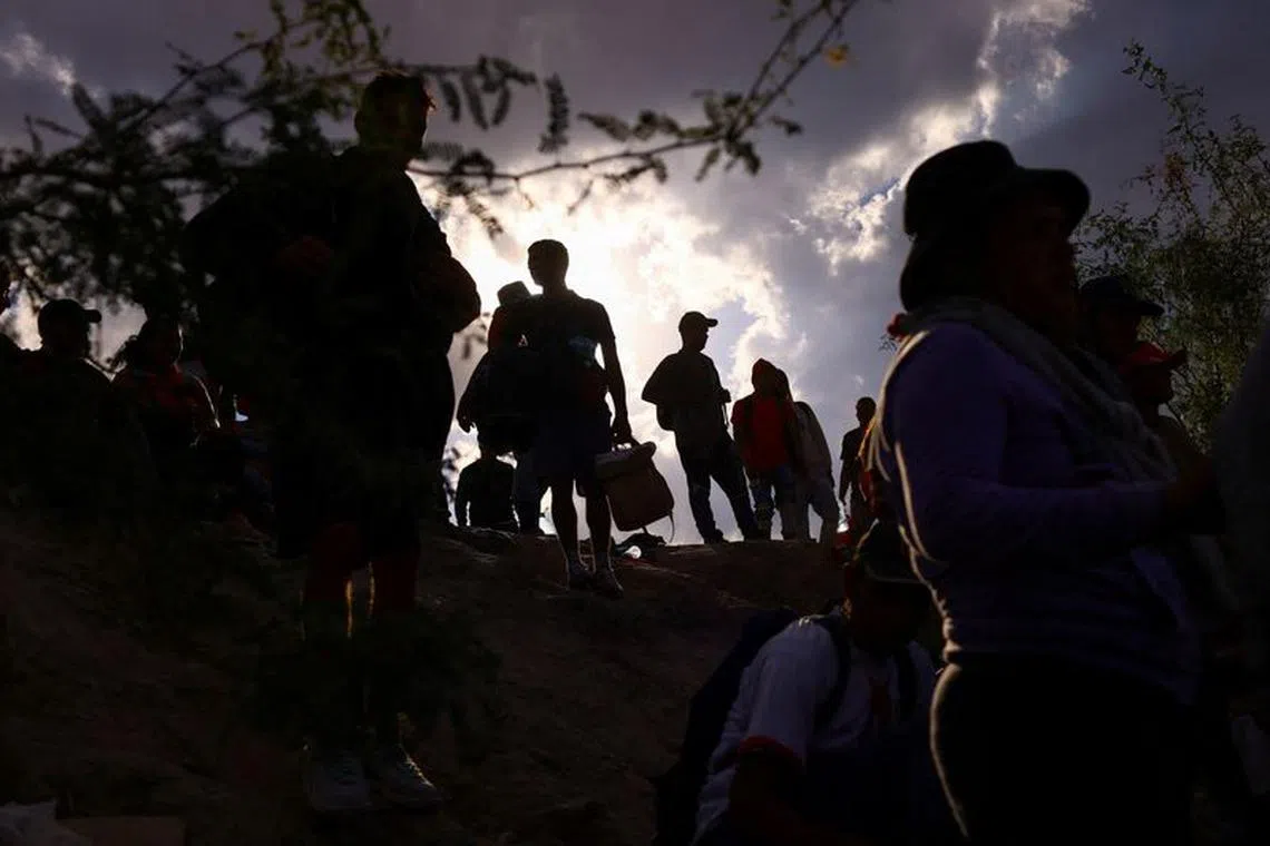 FILE PHOTO: Migrants cross the Rio Bravo River with the intention to request asylum in the United States, as seen from Ciudad Juarez, Mexico, October 3, 2023. REUTERS/Jose Luis Gonzalez/File Photo