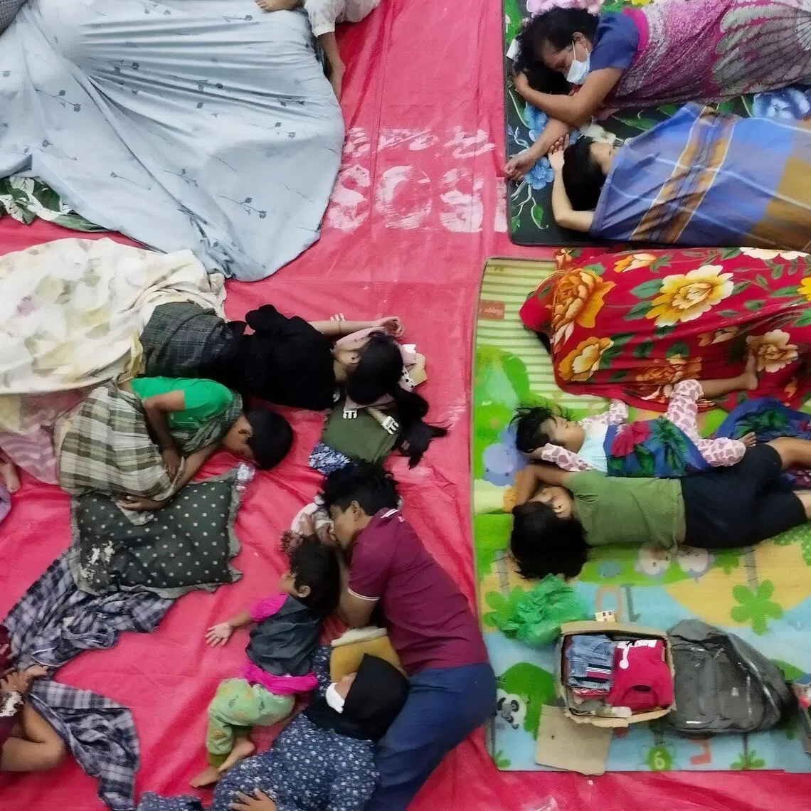 Flood-affected residents rest at an evacuation shelter in Central Tapanuli, North Sumatra.
