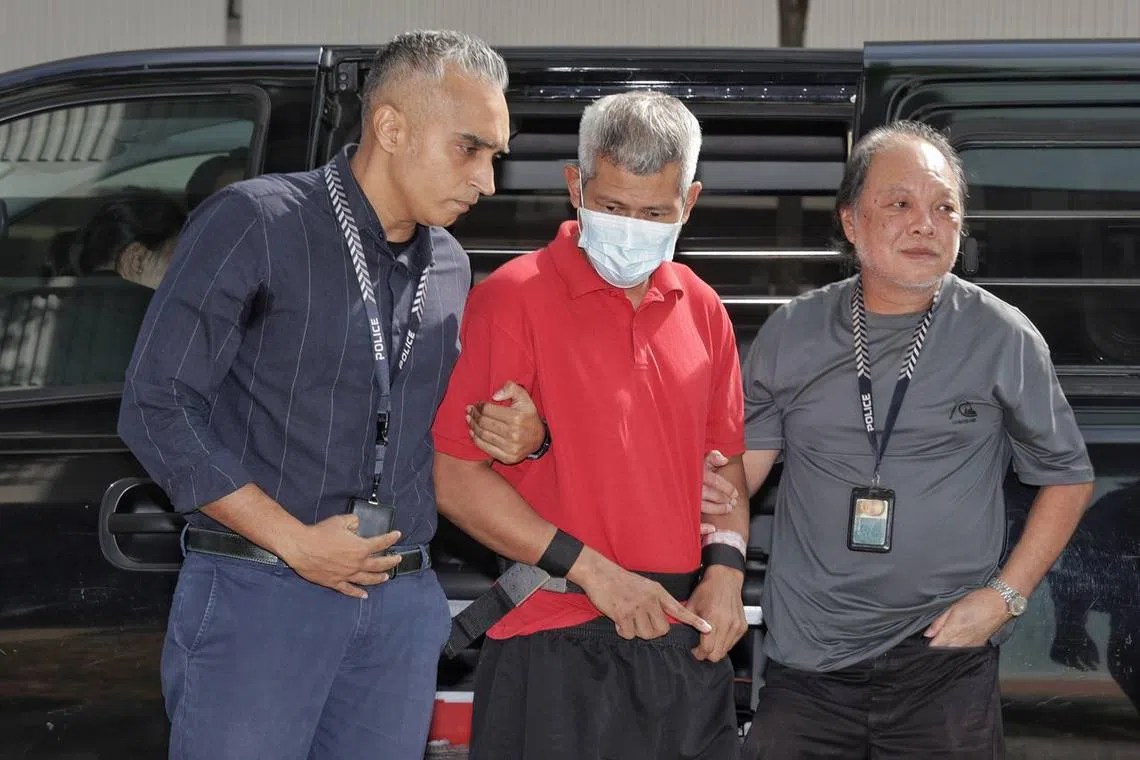 Police bringing the 49-year-old male suspect, who allegedly murdered a 35-year-old man on the morning of July 27, back to the crime scene at 803 Yishun Ring Road on Aug 6, 2024. 