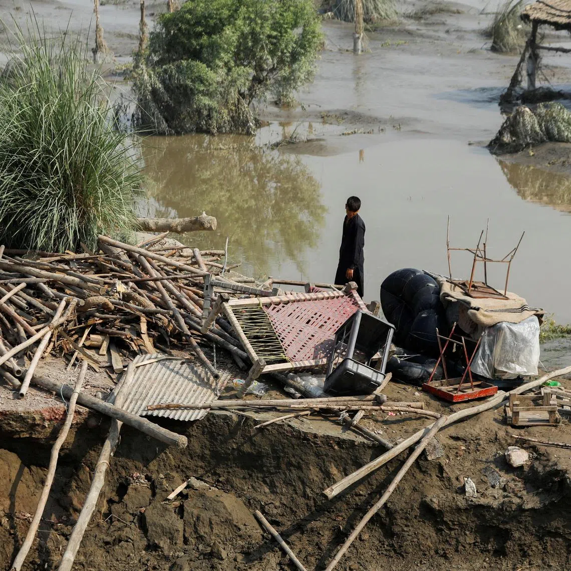 FILE PHOTO: A flood victim stands in his damaged house, following rains and floods during the monsoon season, in Nowshera, Pakistan August 31, 2022. REUTERS/Fayaz Aziz/File Photo