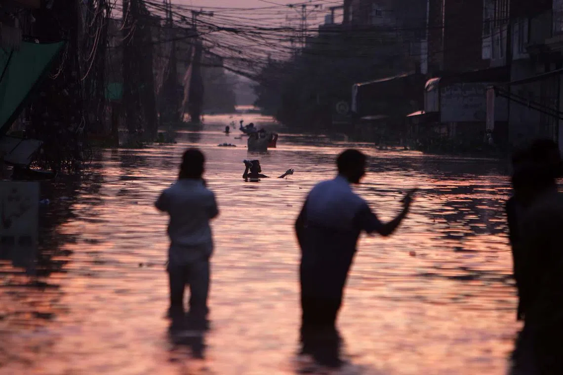 epa12341842 People cross a flooded area after the river Ravi overflowed in Lahore, Punjab province, Pakistan, 31 August 2025 (issued 01 September 2025). At least 33 people have died and more than 1.4 million people have been affected in Punjab province after heavy monsoon rains, melting glaciers, and water releases from Indian dams caused three rivers to overflow, triggering severe flooding and 'exceptionally high' water levels, officials said. EPA/SOHAIL SHAHZAD