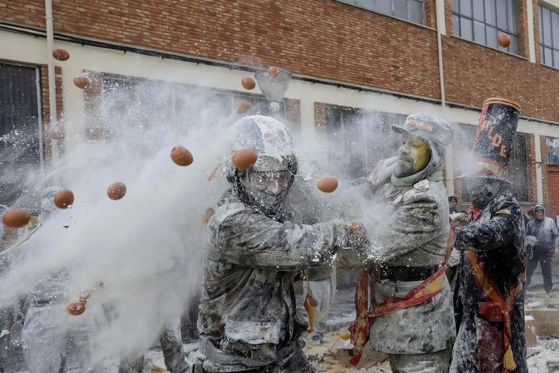 Revellers battling with flour and eggs during the traditional "Els Enfarinats" (The Floured) festival in Ibi, Spain, Dec 28, 2023. 